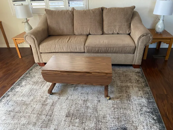 a living room with furniture and a rug