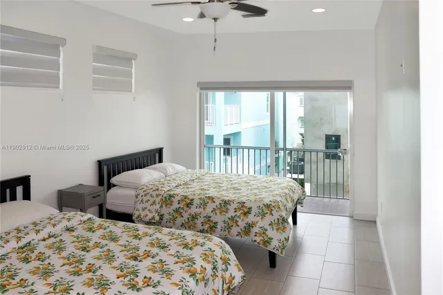 a bedroom with two beds and a window