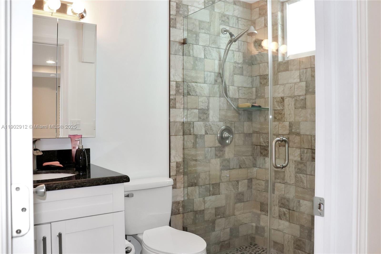 94825 Overseas Highway, Unit 172 Key Largo, FL 33037 - Photo 17 of 40 a bathroom with a sink a toilet and shower