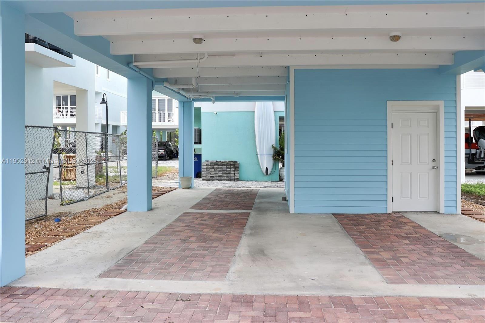 94825 Overseas Highway, Unit 172 Key Largo, FL 33037 - Photo 22 of 40 a view of a hallway with wooden floor and a living room