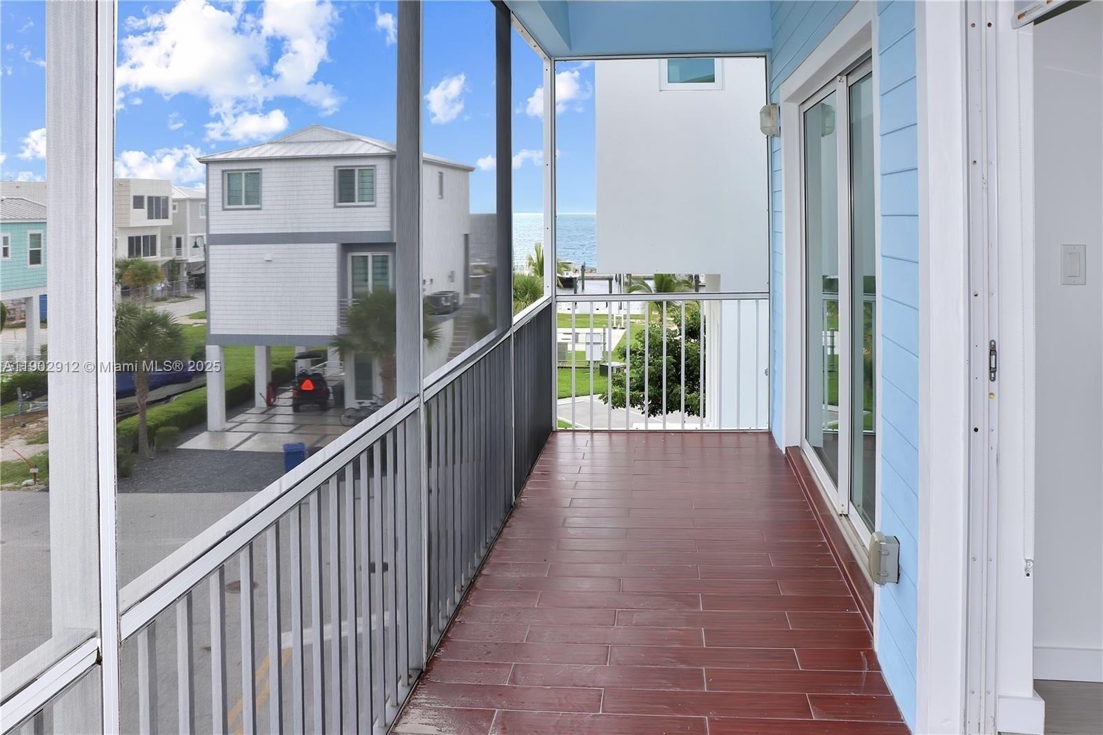 94825 Overseas Highway, Unit 172 Key Largo, FL 33037 - Photo 23 of 40 a view of a balcony with wooden floor