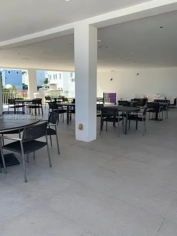 a view of a dining room with furniture and a kitchen