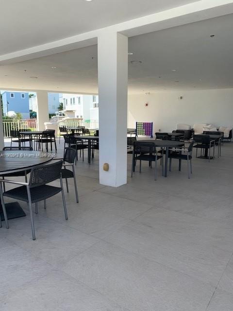 94825 Overseas Highway, Unit 172 Key Largo, FL 33037 - Photo 25 of 40 a view of a dining room with furniture and a kitchen