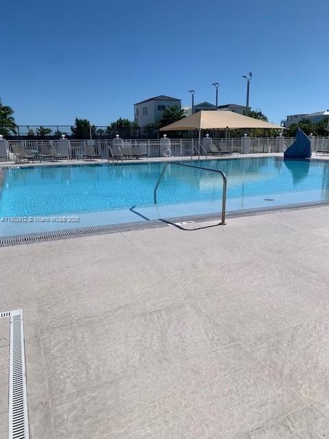 94825 Overseas Highway, Unit 172 Key Largo, FL 33037 - Photo 26 of 40 a blue swimming pool is sitting in front of the lake