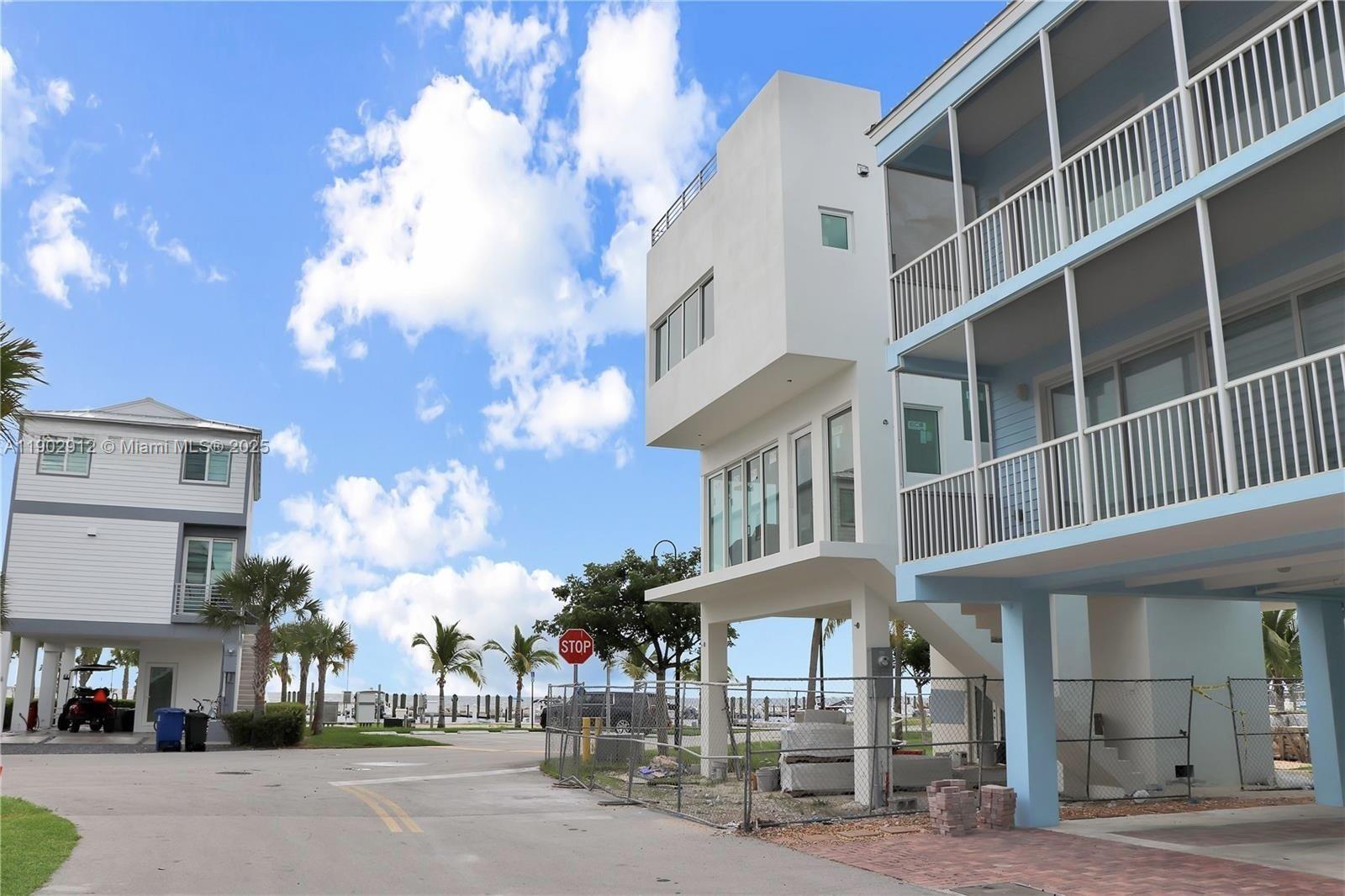 94825 Overseas Highway, Unit 172 Key Largo, FL 33037 - Photo 27 of 40 a city street lined with tall buildings and a cars parked