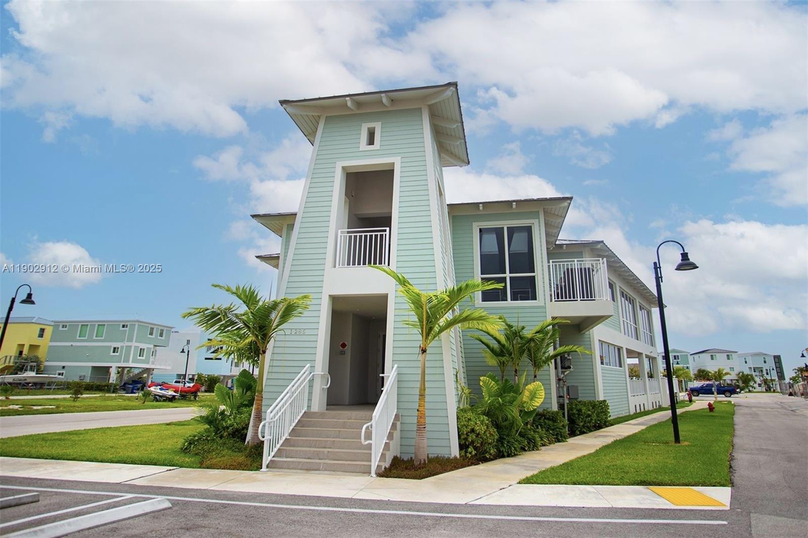 94825 Overseas Highway, Unit 172 Key Largo, FL 33037 - Photo 29 of 40 a front view of a house with garden
