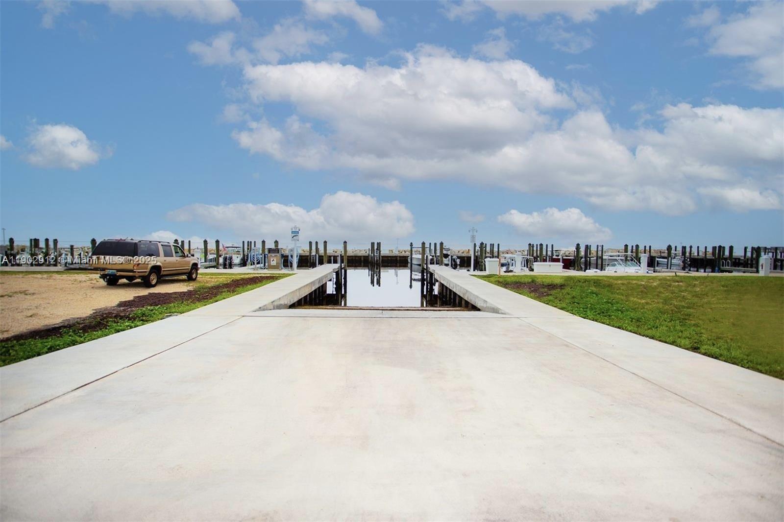 94825 Overseas Highway, Unit 172 Key Largo, FL 33037 - Photo 32 of 40 a view of swimming pool that has lawn chairs with large trees