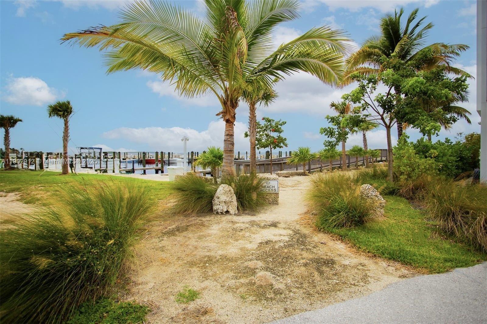 94825 Overseas Highway, Unit 172 Key Largo, FL 33037 - Photo 37 of 40 a view of a lake with palm trees