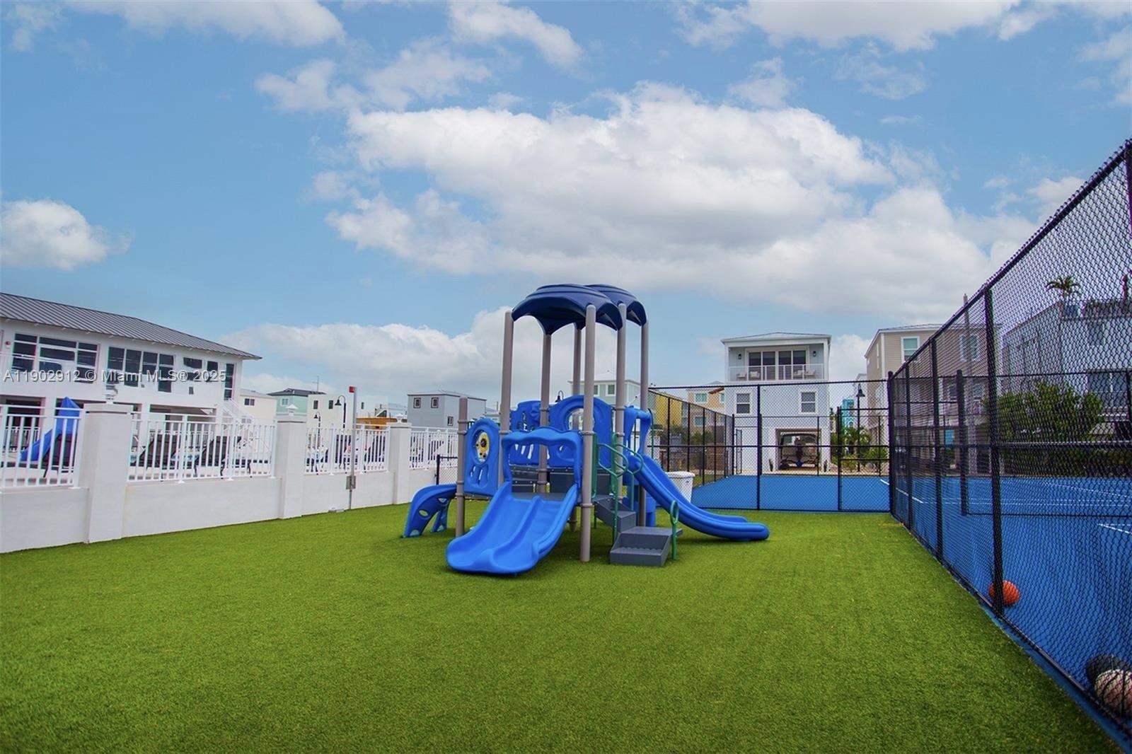 94825 Overseas Highway, Unit 172 Key Largo, FL 33037 - Photo 39 of 40 a view of a park with swings and slides