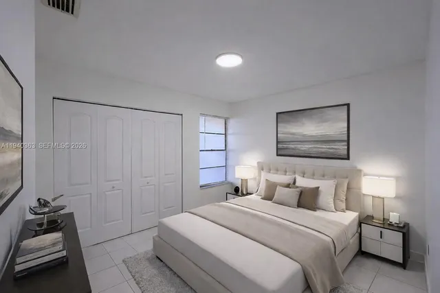 a bedroom with a bed and a couch