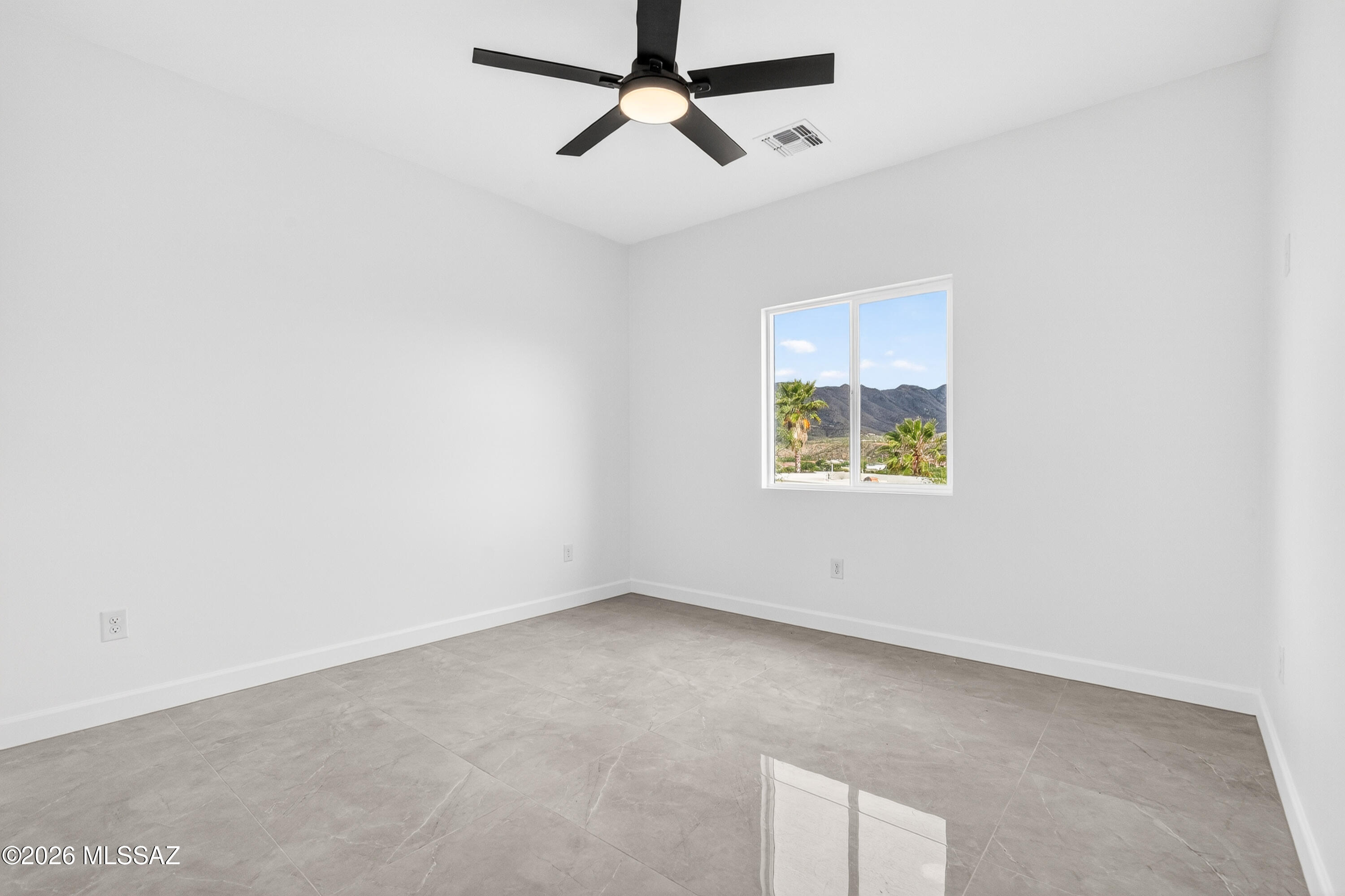 1834 Circulo Glorieta Rio Rico, AZ 85648 - Photo 24 of 35 an empty room with a window and ceiling fan