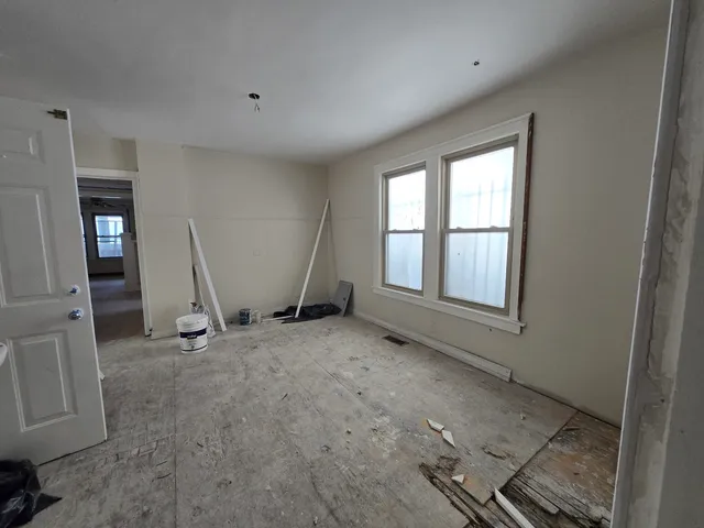 a view of a kitchen with a sink and a refrigerator