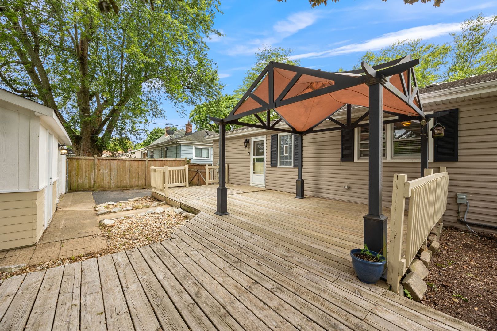 149 Wheeling Avenue Wheeling, IL 60090 - Photo 2 of 23 a front view of a house with wooden floor and a bench