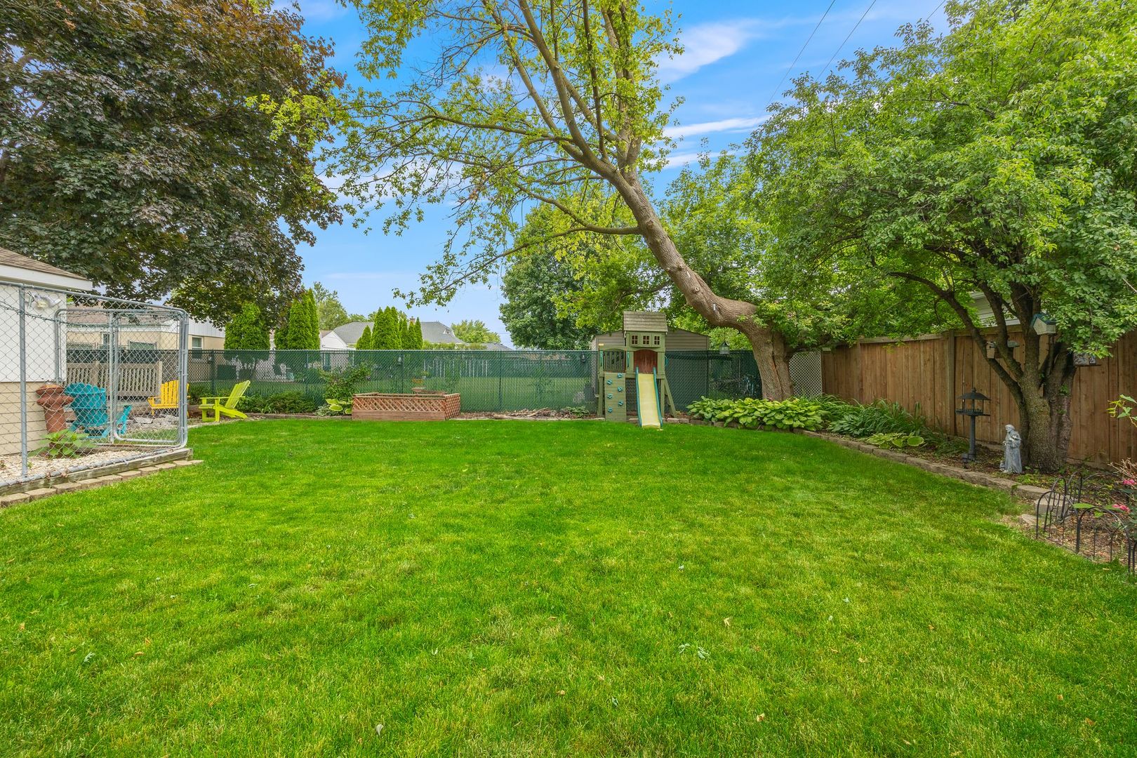 149 Wheeling Avenue Wheeling, IL 60090 - Photo 21 of 23 a view of a house with backyard and a tree