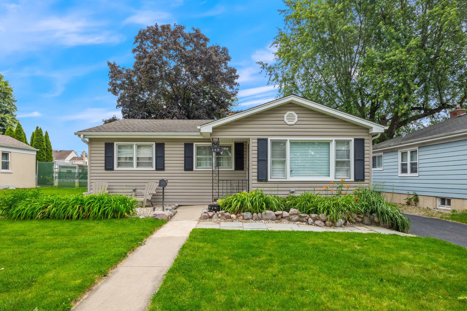 149 Wheeling Avenue Wheeling, IL 60090 - Photo 23 of 23 a front view of a house with a garden