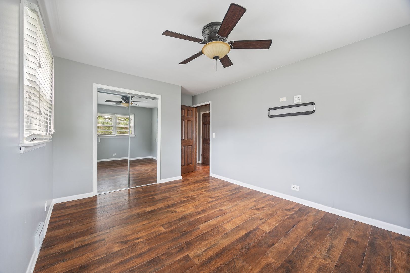 149 Wheeling Avenue Wheeling, IL 60090 - Photo 8 of 23 an empty room with wooden floor and windows