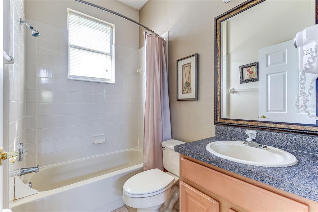 918 Algare Loop Windermere, FL 34786 - Photo 23 of 73 a bathroom with a granite countertop sink toilet and shower
