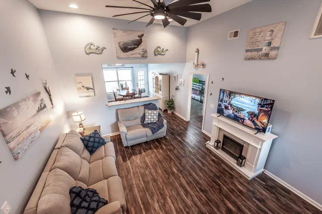 a living room with furniture and a chandelier