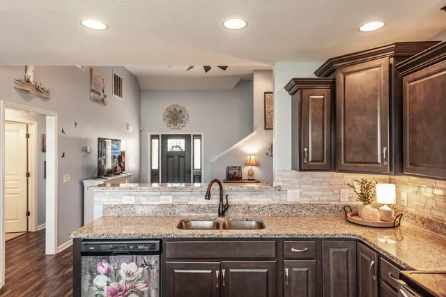 a bathroom with a granite countertop sink a large mirror and a window