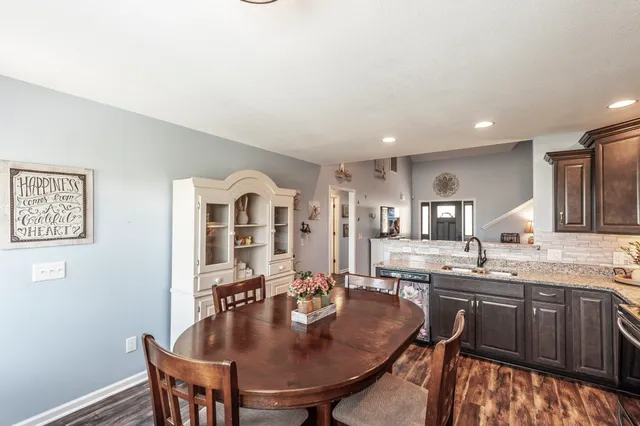 a kitchen with a table chairs sink and cabinets