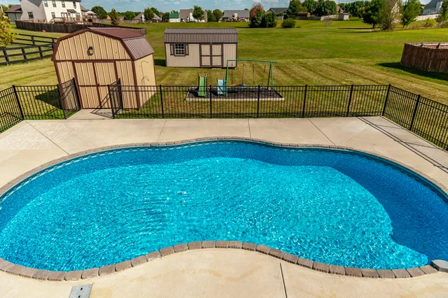 a view of a swimming pool with a lounge chairs