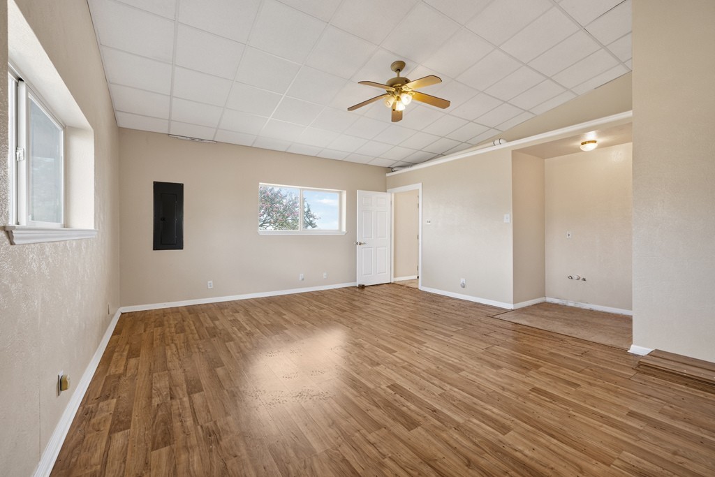 8804 Williamson Road Buda, TX 78610 - Photo 15 of 37 Smooth wood-look flooring and clean neutral walls anchor this versatile, open living area.