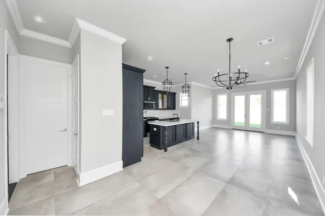 a view of a kitchen with a sink and refrigerator