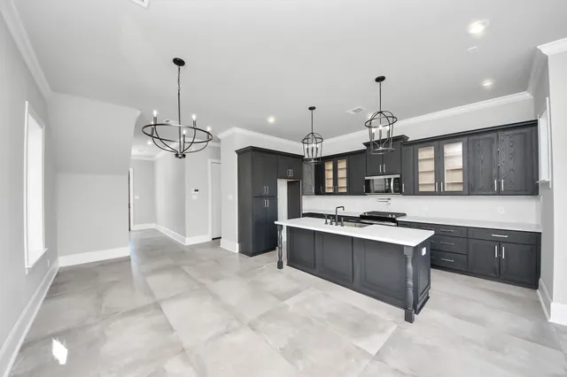 a large kitchen with a table and chairs