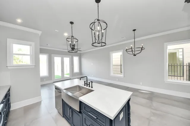 a kitchen with stainless steel appliances granite countertop a sink stove and cabinets