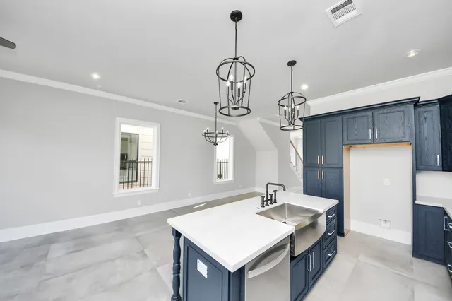 a kitchen with a stove a sink and a refrigerator
