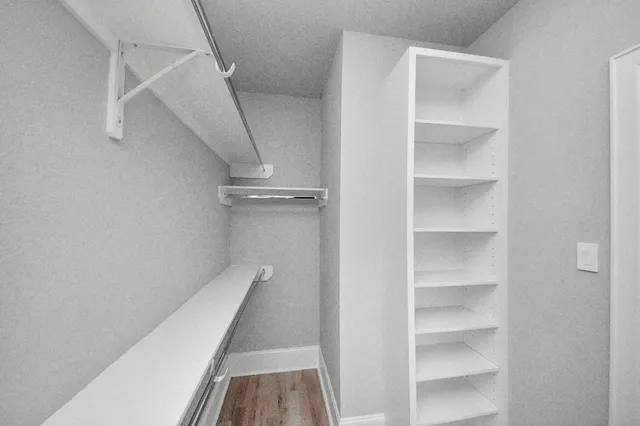 a spacious bathroom with a granite countertop sink mirror and toilet