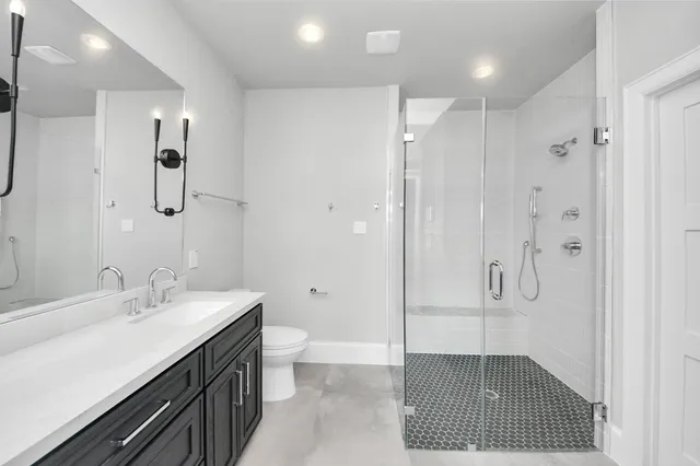 a bathroom with a double vanity sink a mirror and shower