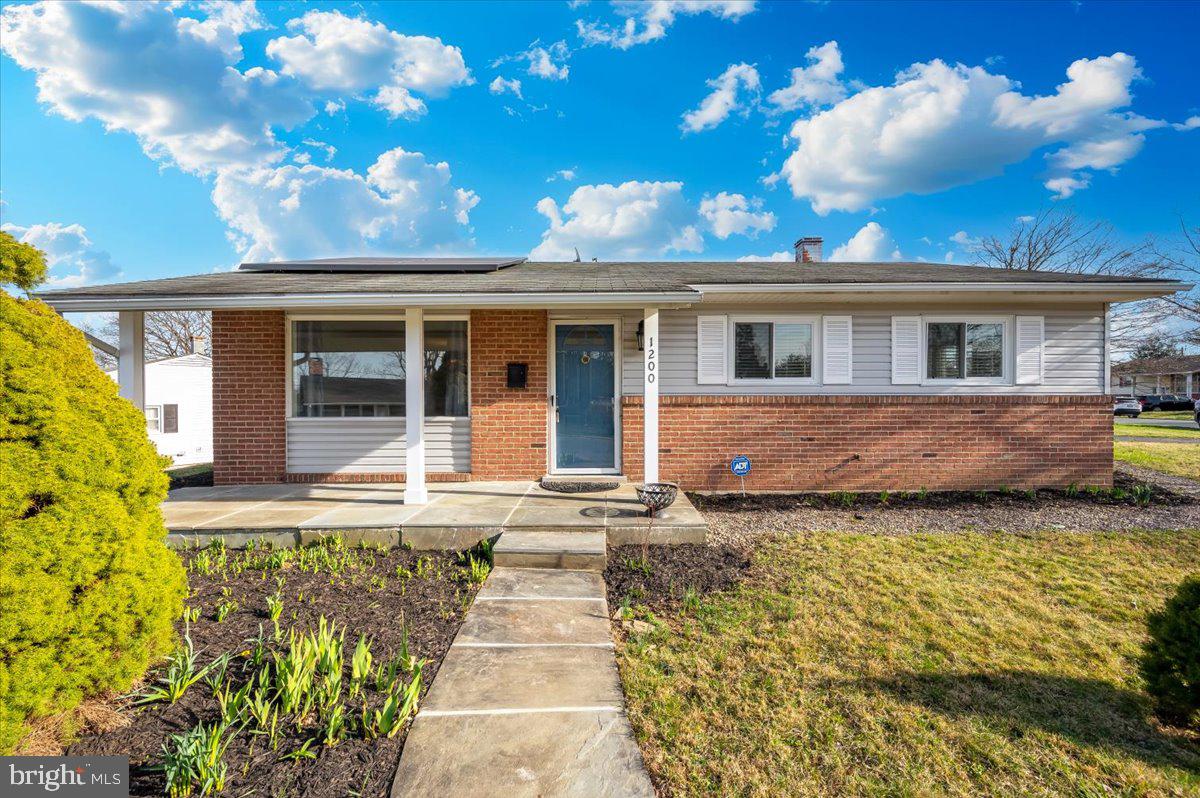 1200 Wilson Place Frederick, MD 21702 - Photo 1 of 57 a front view of a house with a garden