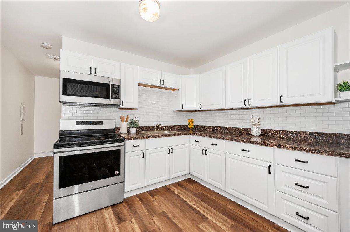 1200 Wilson Place Frederick, MD 21702 - Photo 12 of 57 a kitchen with granite countertop cabinets stainless steel appliances and a sink