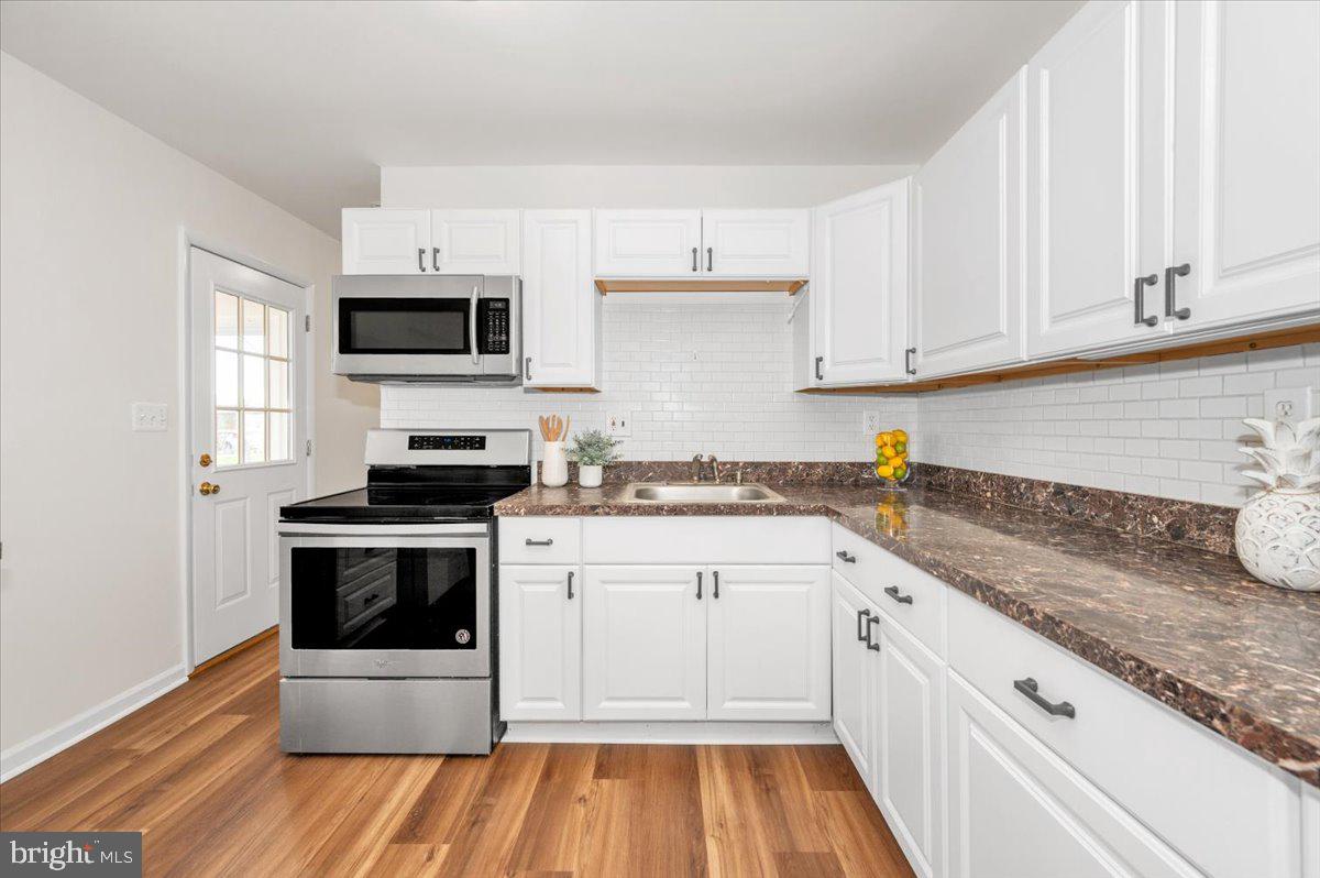 1200 Wilson Place Frederick, MD 21702 - Photo 14 of 57 a kitchen with granite countertop a sink and steel appliances