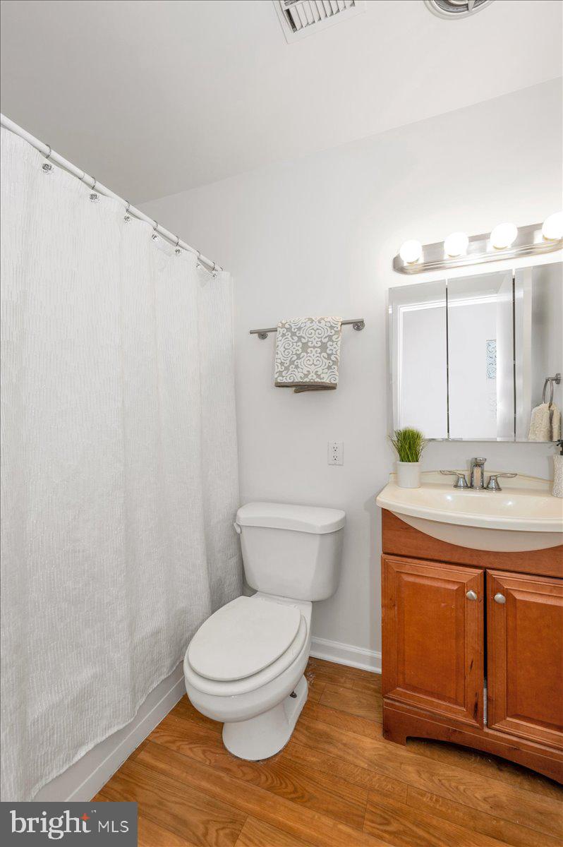 1200 Wilson Place Frederick, MD 21702 - Photo 33 of 57 a bathroom with a granite countertop toilet sink and mirror