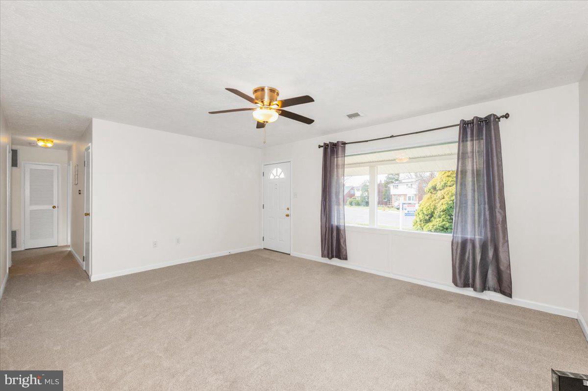 1200 Wilson Place Frederick, MD 21702 - Photo 4 of 57 an empty room with windows and a ceiling fan