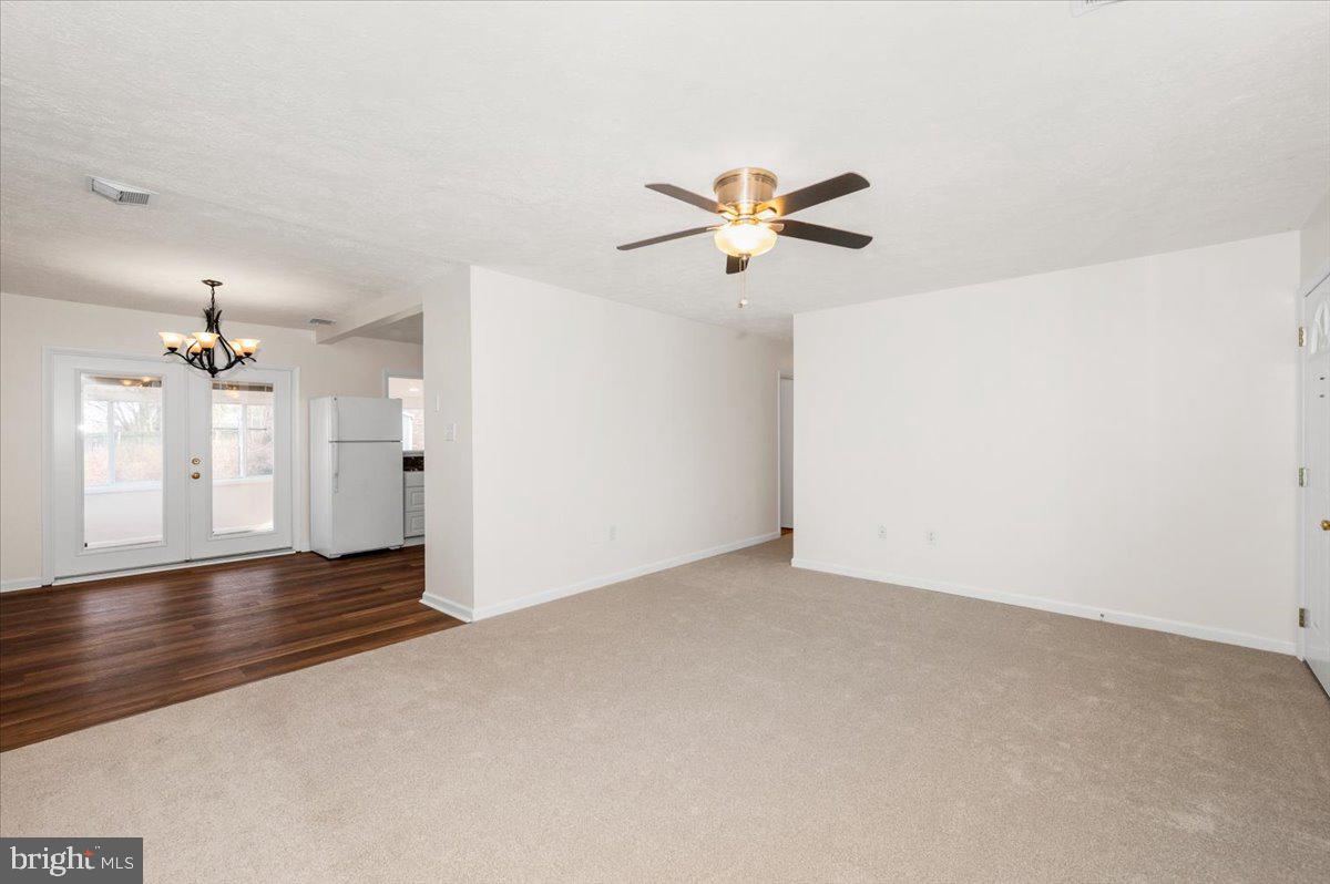 1200 Wilson Place Frederick, MD 21702 - Photo 5 of 57 an empty room with wooden floor and windows