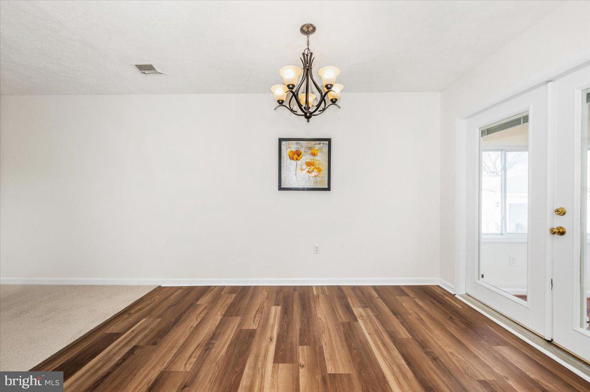 1200 Wilson Place Frederick, MD 21702 - Photo 9 of 57 a view of a room with wooden floor and a ceiling fan