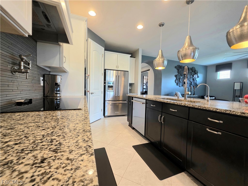 10805 Dennington Road Fort Myers, FL 33913 - Photo 12 of 45 a kitchen with stainless steel appliances kitchen island granite countertop a refrigerator and a sink