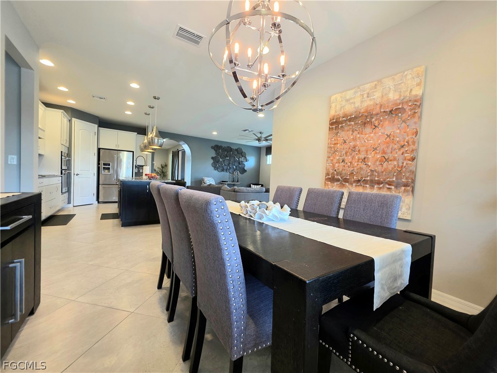 10805 Dennington Road Fort Myers, FL 33913 - Photo 19 of 45 a dining room with furniture and chandelier