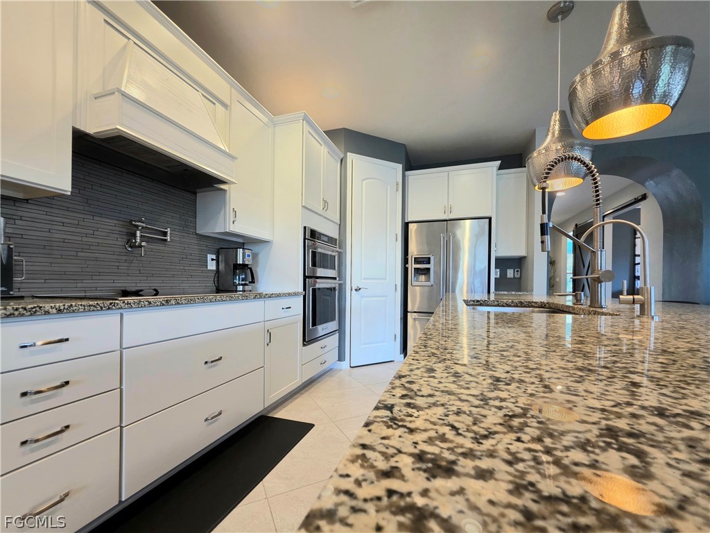 10805 Dennington Road Fort Myers, FL 33913 - Photo 20 of 45 a kitchen with stainless steel appliances granite countertop a granite counter tops and a refrigerator