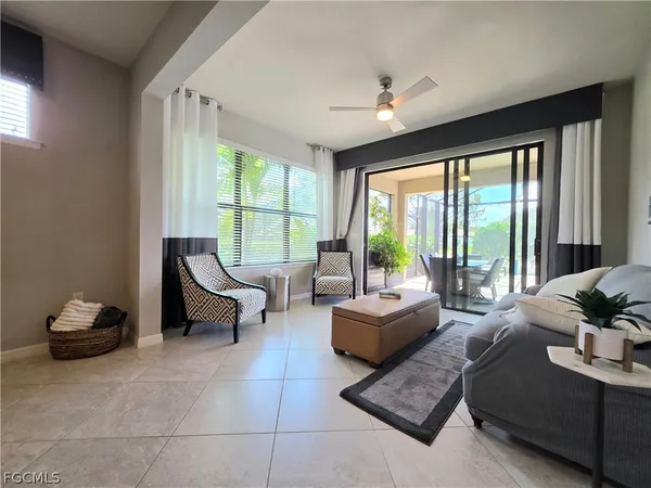 a living room with furniture and floor to ceiling windows