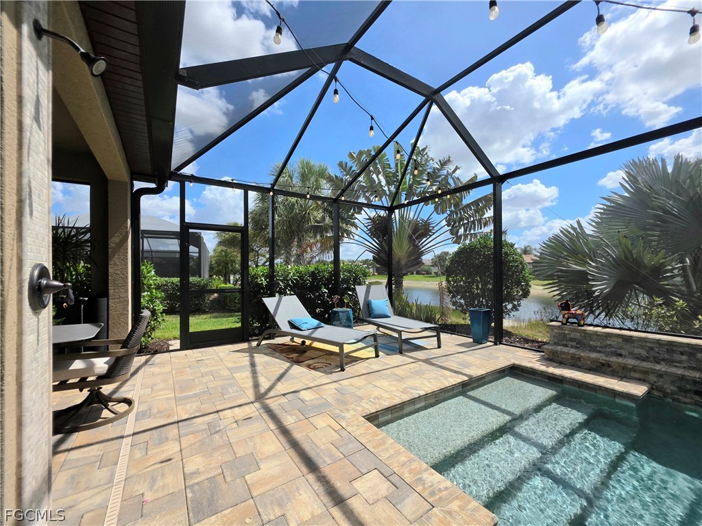 10805 Dennington Road Fort Myers, FL 33913 - Photo 35 of 45 a view of patio with a table and chairs under an umbrella