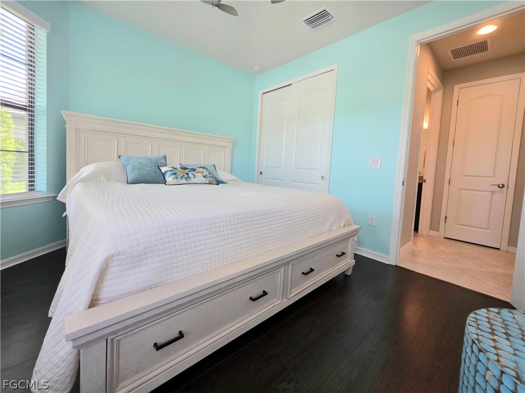 10805 Dennington Road Fort Myers, FL 33913 - Photo 8 of 45 a bedroom with a bed and wooden floor
