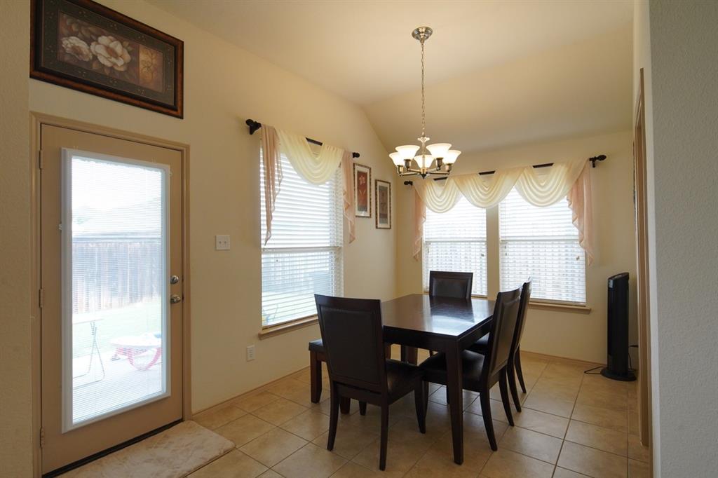4508 Fox Rio Trail Arlington, TX 76017 - Photo 10 of 28 a dining room with furniture a chandelier and window