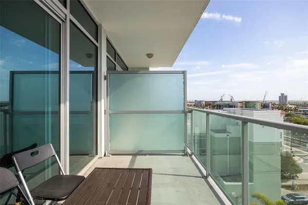 a balcony with view of car parked