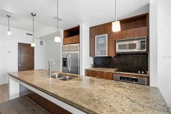 a bathroom with a granite countertop sink and a mirror