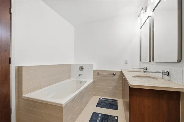 a bathroom with a double vanity sink and mirror
