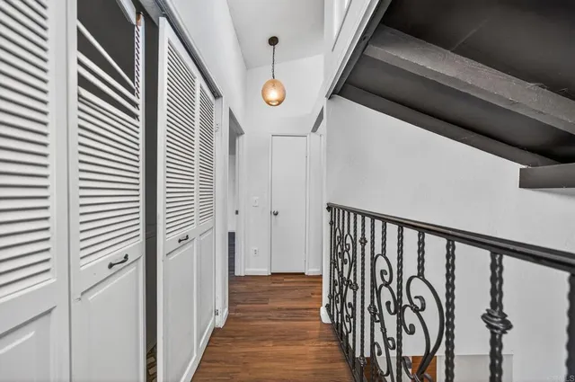 a view of a hallway with wooden stairs